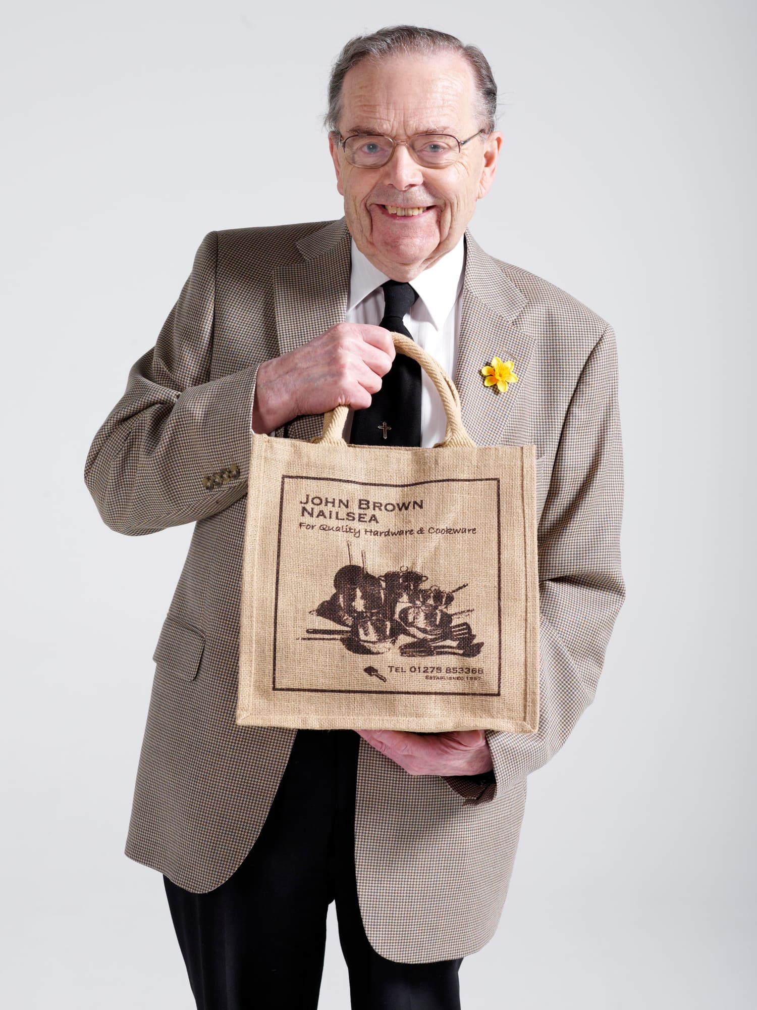 John Brown holding a John Brown Hardware shop bag