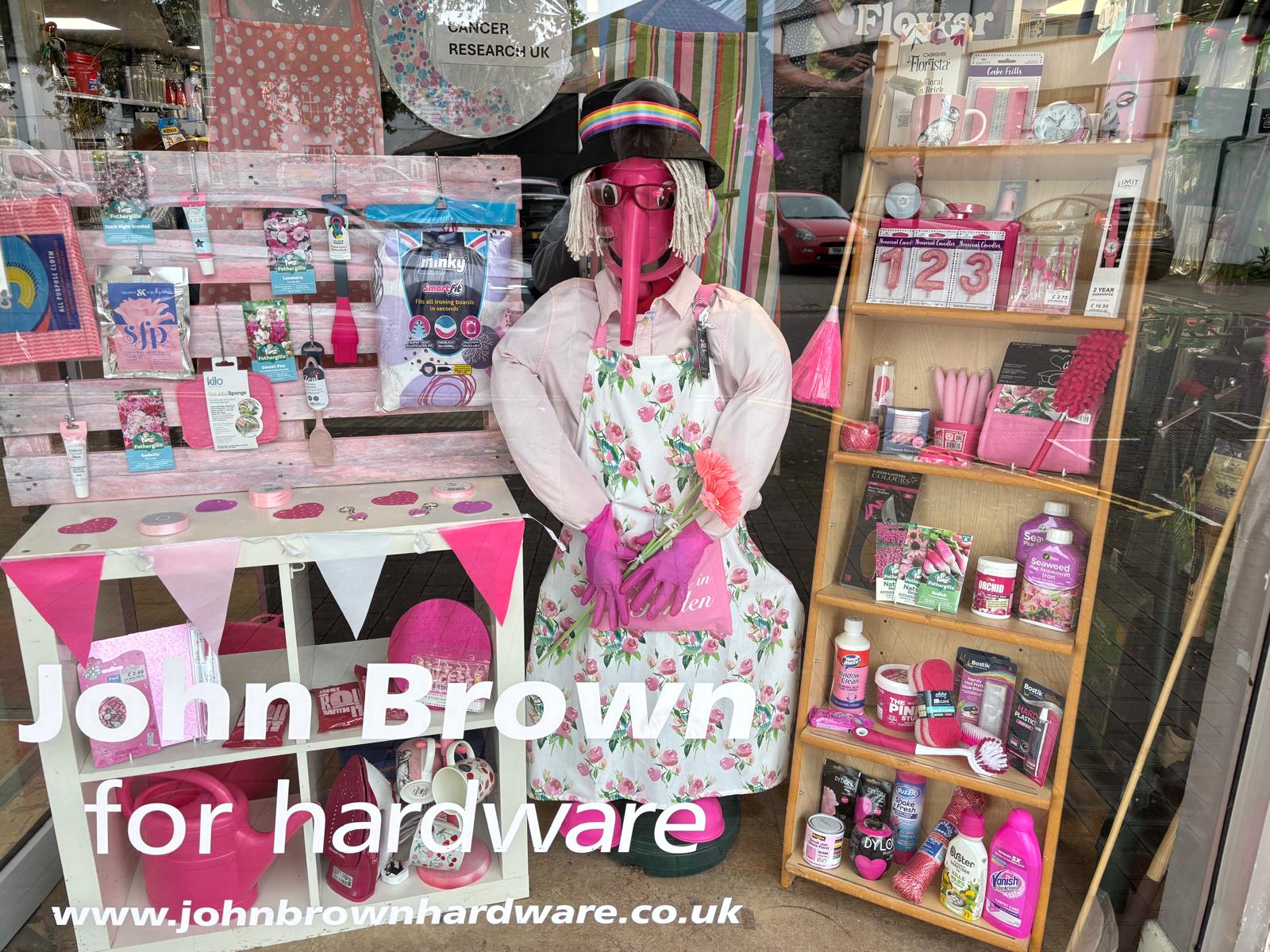 John Brown Hardware shop window filled with pink products and a display supporting Cancer Research UK